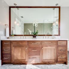 Gorgeous, Large Wood Vanity in Transitional Bathroom With White Marble Floor and Simple Pendant Lights