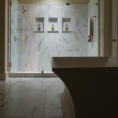 White Marble Walk-In Shower With Gold Details and Built-In Shelving 