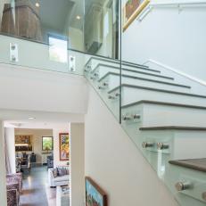 Modern Glass-Lined Staircase With Wood-Topped Steps and White Walls 