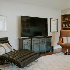 Black Leather Chaise, Tufted Brown Leather Chair and Distressed Finish TV Shelf In Midcentury Modern Living Room 