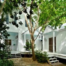White Exterior With Porches and Trees