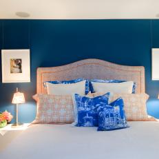 Modern Blue and Orange Bedroom With Neutral Floral Wallpaper