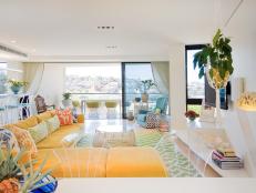 Open Air Living Space With Yellow Sofa and Multicolored Floral Pillows