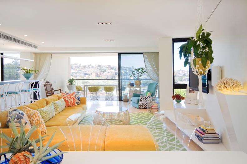 Open Air Living Space With Yellow Sofa and Multicolored Floral Pillows