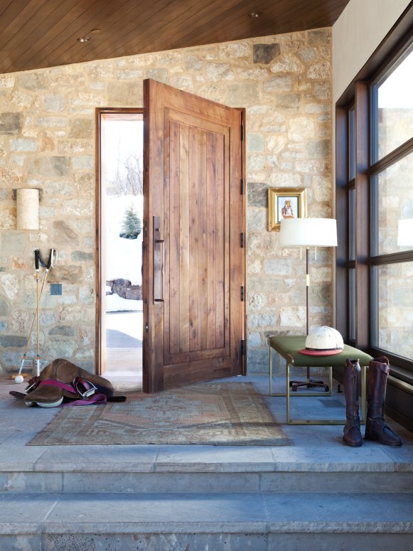 Neutral and Gray Stone Entrance With Brown Wooden Door