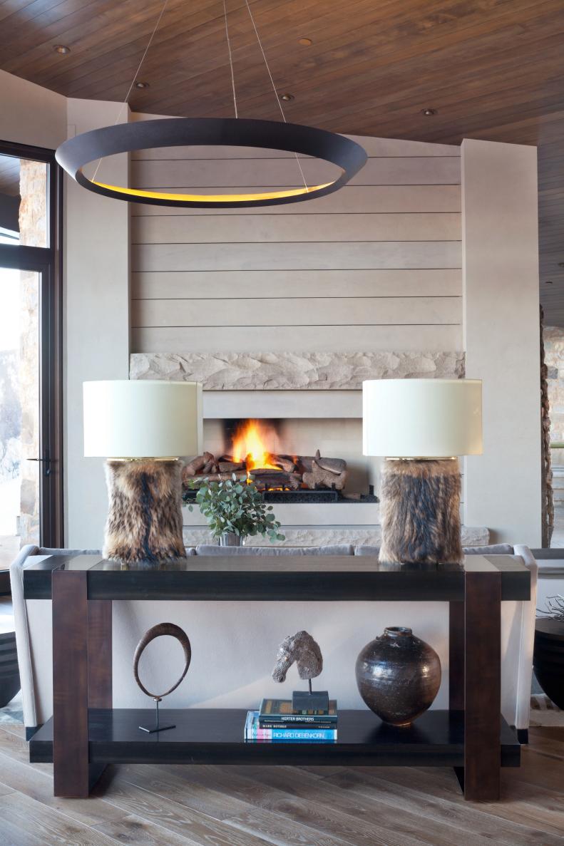 Neutral Living Room With Circular Chandelier and Fur Lamps