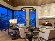 Neutral Living Room With Stone Fireplace and Mountain View