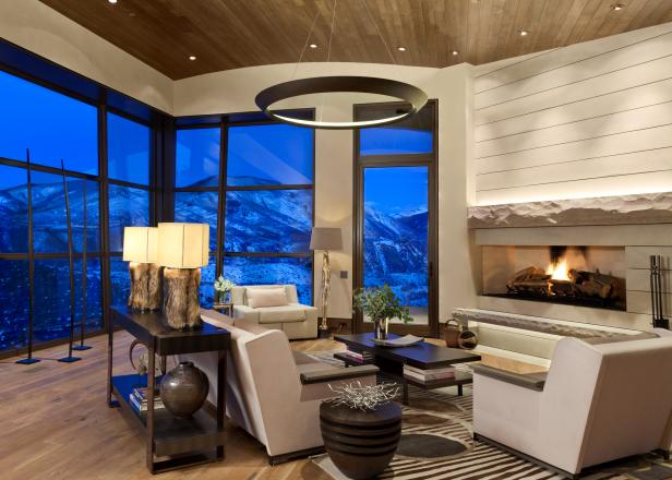 Neutral Living Room With Stone Fireplace and Mountain View