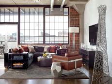White Living Room With Exposed Brick Wall and City View