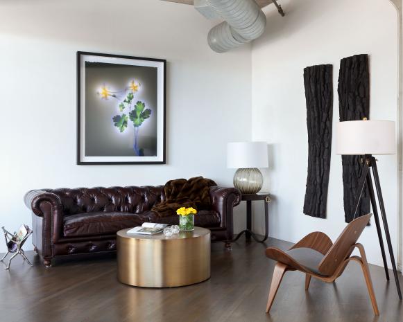 White Sitting Room With a Brown Leather Sofa and Gold Coffee Table 