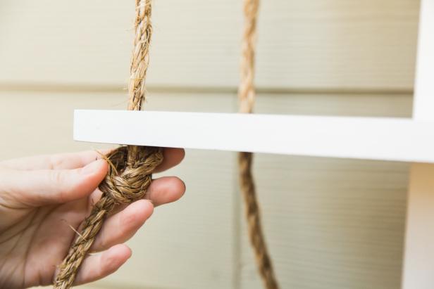 Once the bottom shelf is hung, tie off the ropes into a knot on either side, then trim them with a utility knife. For an interesting texture, you can pull apart the ends of the ropes for a fringed look. Now you’re ready to hang the shelf- just be sure to use the proper hardware and anchors! HINT- If you hang the shelf in a bathroom, over time the steam will help the rope straighten out a bit!