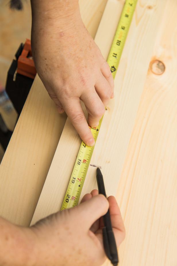 If you’re not into using a jigsaw or circular saw you can easily pick up an 8 foot long piece of 1”x 4” at the home improvement store and have them cut a few 18 inch long pieces. If not, measure, mark and cut them yourself at home. Be sure to use eye protection!  Cut at least three or four boards, as they’ll support the rolling base. We went with three but if we built it again we’d go with four to make it even sturdier!