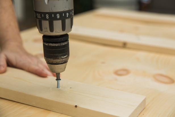 Once your 1x4s are cut, lay them out across the shelving boards and fasten together using 2 inch wood screws, making sure to keep the two shelving boards butted together tightly, as you work. HINT: To ensure a strong base that doesn’t bow under the weight of the pipe, make sure the outer 1x4s are as close to the edge as possible while still leaving room for the casters which you’ll install next.