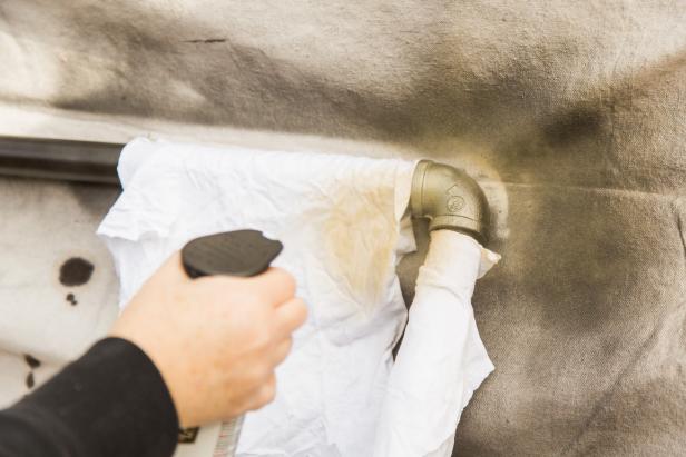 Once dry, go back and hit the elbows (and flanges if you like) with a brushed or antique gold spray paint to give it a vintage look. Use rags or painters tape to protect the pipe you don’t wish to paint.