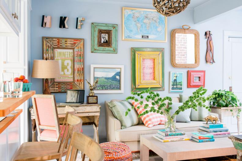 Every square inch of this small living room was used both functionally and decoratively, from walls covered in art to appropriately apartment-sized furniture and a mix of light and bright colors.