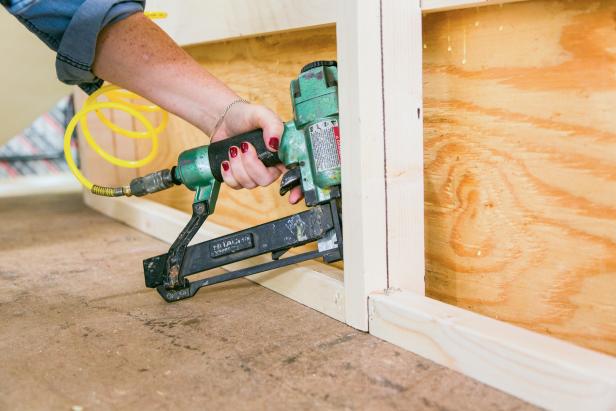 Take the extra 1”x3” you cut in Step 5 and measure, mark and cut it in half so that the two pieces fit snugly between the side and middle vertical support boards. Then, fasten the boards to the vertical supports using wood glue and nail gun.