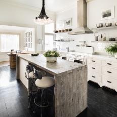 Bright Country Kitchen With Natural Wood Island, Black Wood Floor and White Subway Tile Backsplash 