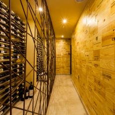 Long Hallway Wine Cellar With Wine Crate Walls and Iron Grate Entry to the Wine Shelves 