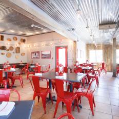 Contemporary Rustic Restaurant With Red Metal Chairs
