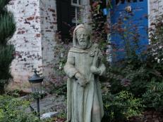 A statute of St. Fiacre – the patron saint of gardeners – holds a prominent spot in the front of the English cottage. Behind the home, the garden has smaller sculptures of St. Fiacre and St. Francis, the patron saint of nature. “You need all the help you can get,” Katie Sanstead said.