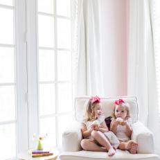 Pink Girl's Room With White Armchair