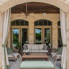 Relaxing Stacked Stone Patio With Outdoor Curtains
