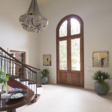 Bright Transitional Foyer With Tall Wooden Front Doors
