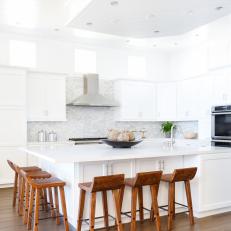 White Open Kitchen With Modern Wooden Bar Stools
