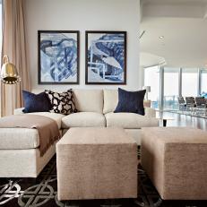 Neutral and Blue Sitting Room With Ottomans