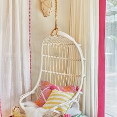 White Hanging Ratan Chair in Girls' Playroom