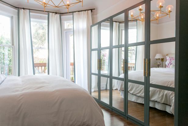 Transitional Bedroom With White Linens & Mirrored Doors