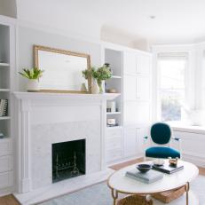 Marble Fireplace & Built-In Shelving in Bright, Airy Living Area