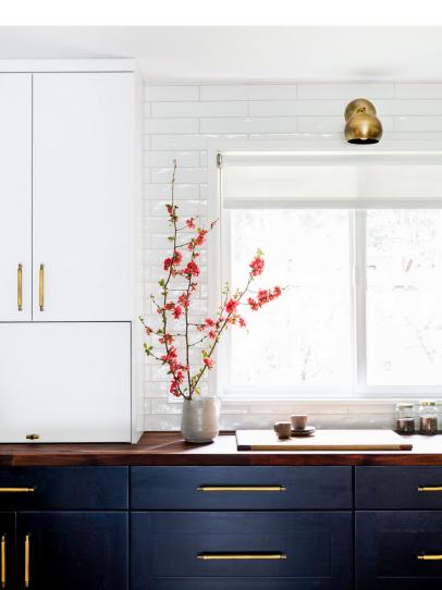 Two tone kitchen cabinets store with dark countertops