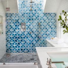 Blue Patterned Tile Accent Wall in Spacious Glass Door Shower With White Subway Tile Walls and Gray Marble Flooring 