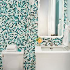 Turquoise Flower Petal Wallpaper in Contemporary Bathroom With Sleek White Vanity Sink and Sconce With Pom Pom Trim 