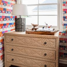 Neutral, Upholstered Nailhead Dresser With Colorful Children's Book Cover Wallpaper Backdrop 