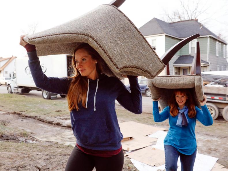 As seen on Good Bones, Mina Starsiak (L) and Karen E Laine bring in furniture to stage the renovated home on Woodlawn. (action)