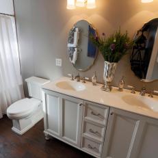 Renovated Master Bathroom with Ornamental Mirrors and Pewter Vase