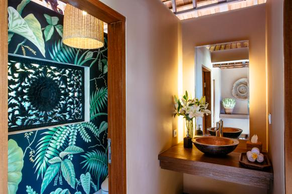 Neutral Tropical Bathroom With Navy & Green Leaf Accent Wall