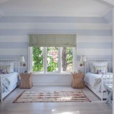 Bright Bedroom With Soft Blue and White Striped Walls, White Twin Beds and Rug Decorated Open Floor Space 