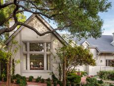 Home Exterior With Neutral Walls, Beige Trim and Small Shrubs in Mulched Garden 