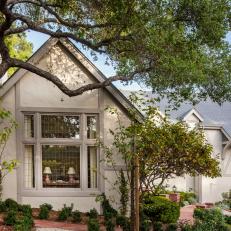 Home Exterior With Neutral Walls, Beige Trim and Small Shrubs in Mulched Garden 