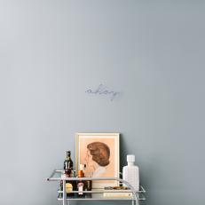 Bar Cart and Gray Wall With Word "Ahoy" Written
