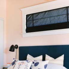Bedroom With Blue Headboard and Wall Art Decor