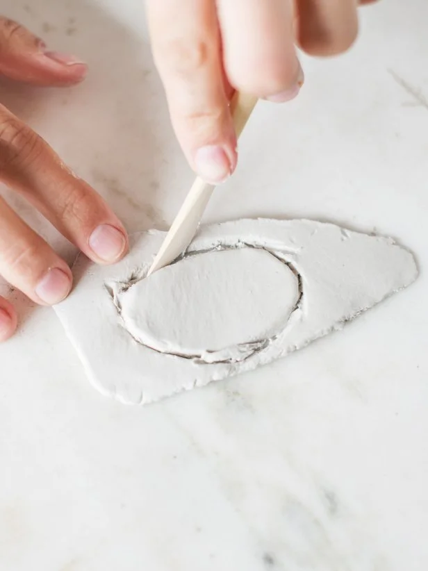 Step 2: Cut ClayUse a wooden clay knife (or kitchen knife) and cut clay in desired shape.  Smooth out rough edges by wetting a finger with water and running it along the edge.