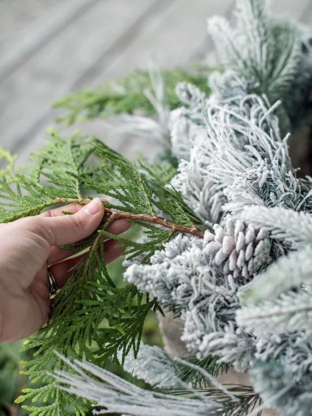 Step 2:  Assemble Greenery and SphereSet a wreath, top-side-up, on top of each urn or planter pot.  Tuck fresh or faux greenery, sprigs, sprays and/or berries into wreath.  Florists wire or hot glue can be used to secure sprigs, if necessary.  Set grapevine sphere on top of wreath, tucking battery packs inside of urn.  Turn on lights and enjoy the beautiful display that took only minutes to create!