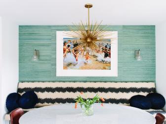 Green-Blue Dining Room With Gold Chandelier and Black and White Bench