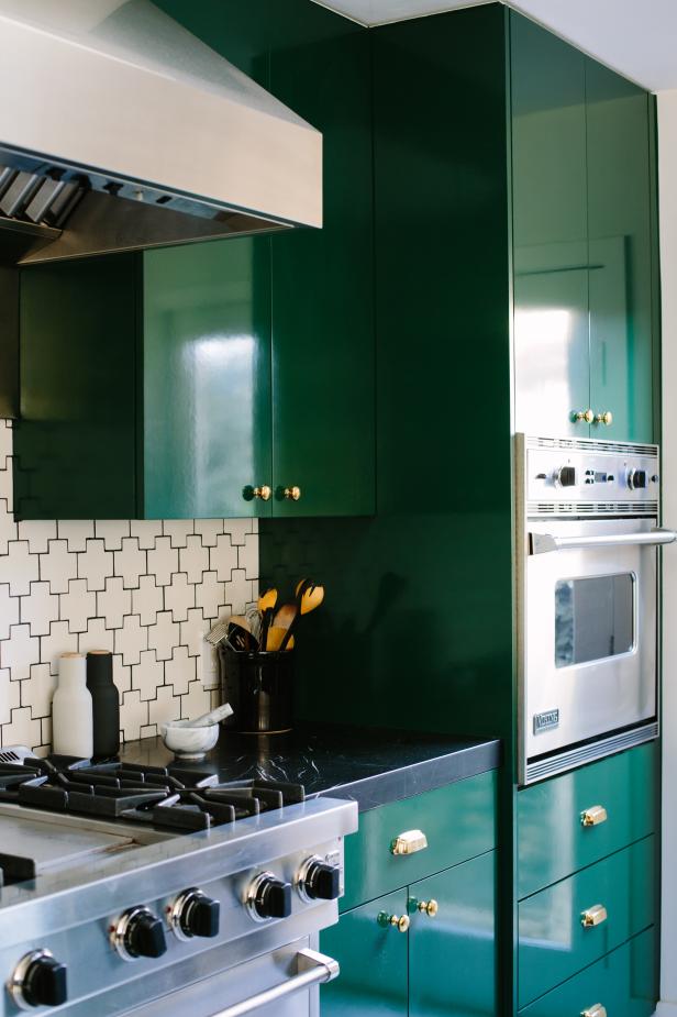 Bold Kitchen With Forest Green Cabinets and Gold Metal 