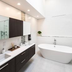 Modern Bathroom With Built-In Double Vanity, White Bathtub and Unique Backsplash