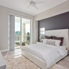 Bright, Contemporary Bedroom With Purple-Gray Accent Wall, Tufted White Headboard and Mirror Wall Paneling 